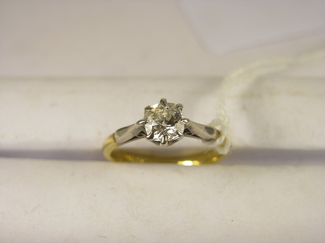 An early 20th century 18ct and platinum diamond solitaire ring set with a single old cushion cut