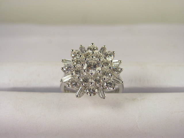 A large 18ct white gold diamond cluster ring set with brilliant and baguette cut diamonds, total