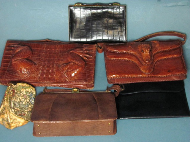 A group of six vintage handbags including crocodile skin with brass fittings.