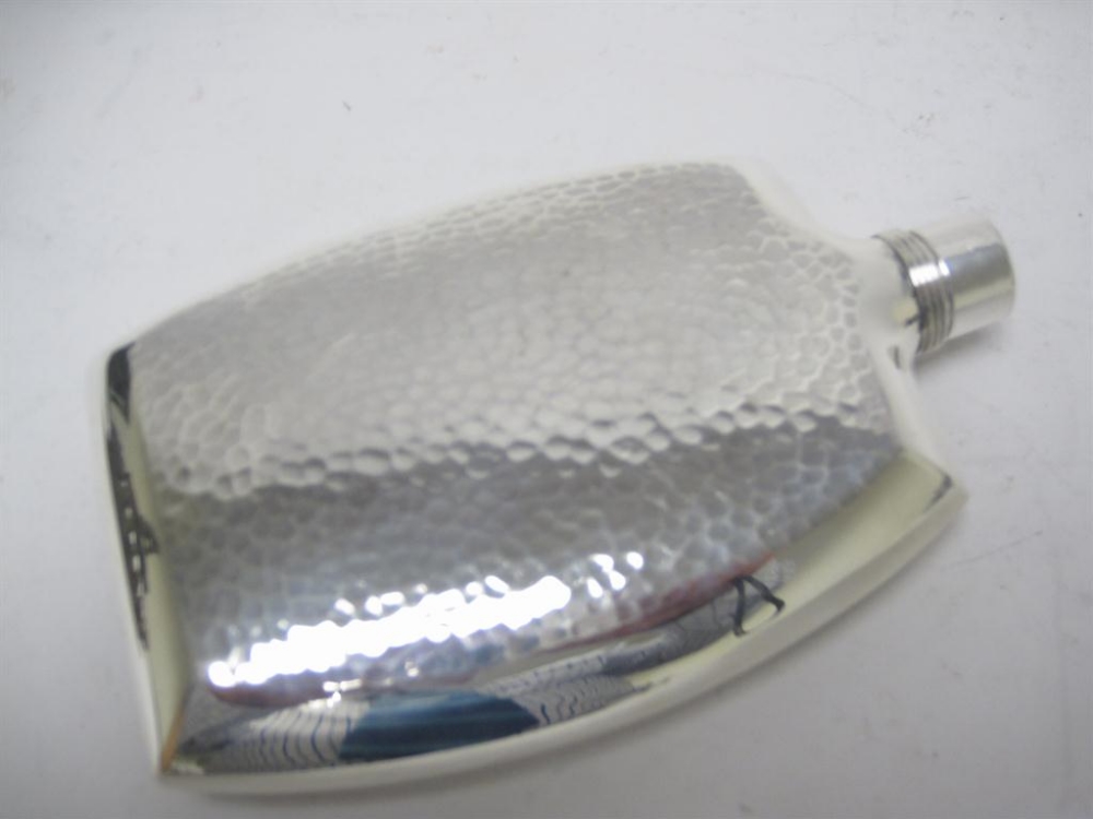 A Hip Flask with hammered design, marked silver