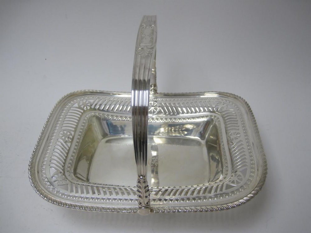 A Victorian oblong Cake basket with pierced frieze, engraved initials, gadroon rim and swing handle,