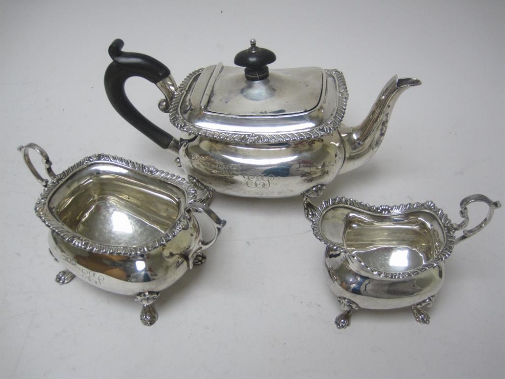 An Edward VII three piece Bachelor`s Tea Service of boat shape with gadroon rims, engraved