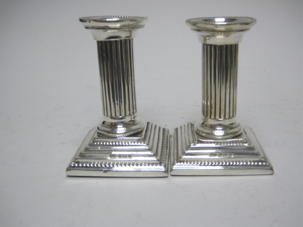 Pair of Edward VII small silver Candlesticks with fluted columns, beaded rims on stepped square