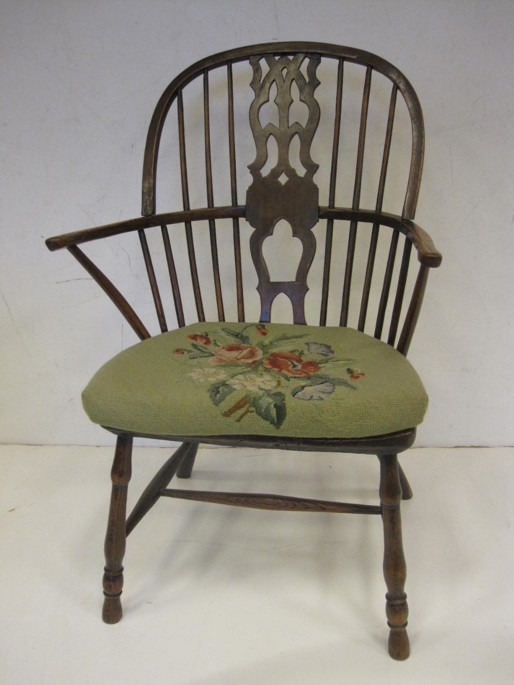 A 19th Century ash and elm Windsor Elbow Chair with pierced splat back on turned supports and
