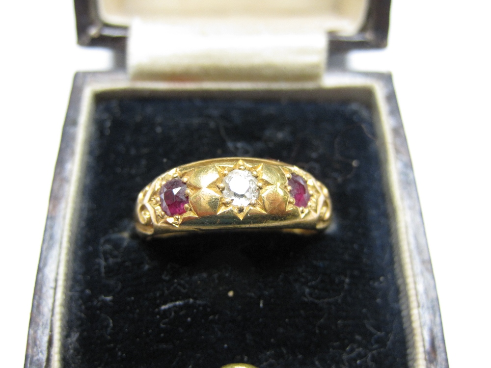 A Ruby and Diamond three stone Ring pavé-set old-cut diamond between two cushion shaped rubies in