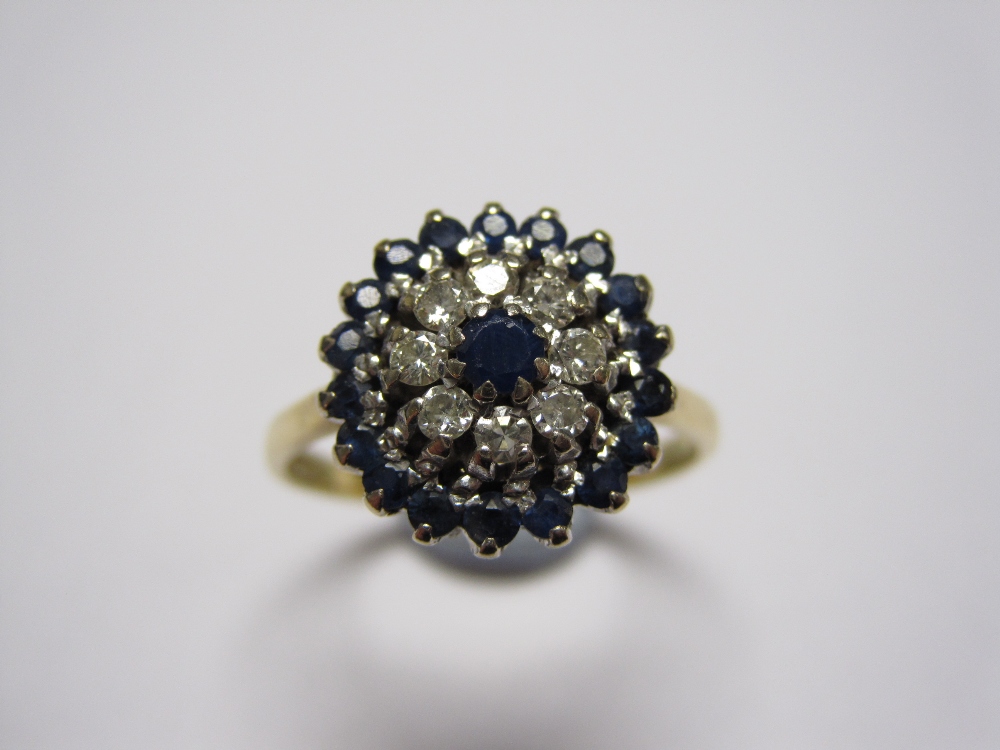 *A Sapphire and Diamond Cluster Ring claw-set circular-cut sapphire within a frame of eight diamonds