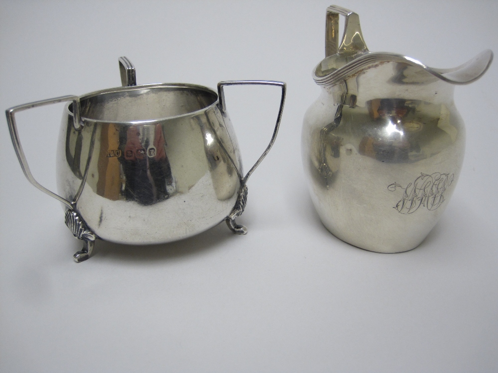 A Victorian oval Cream Jug engraved initials, Birmingham 1898 and a three handled Sugar Bowl,