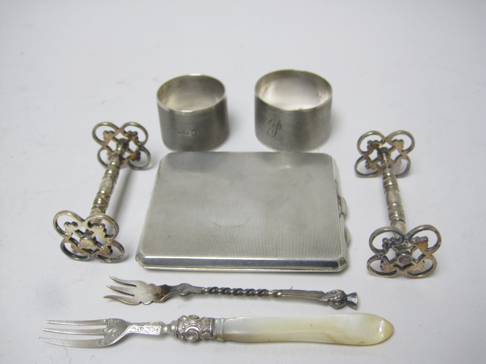 Two engine turned circular Napkin Rings, a Cigarette Case, two Forks and pair of plated Knife Rests