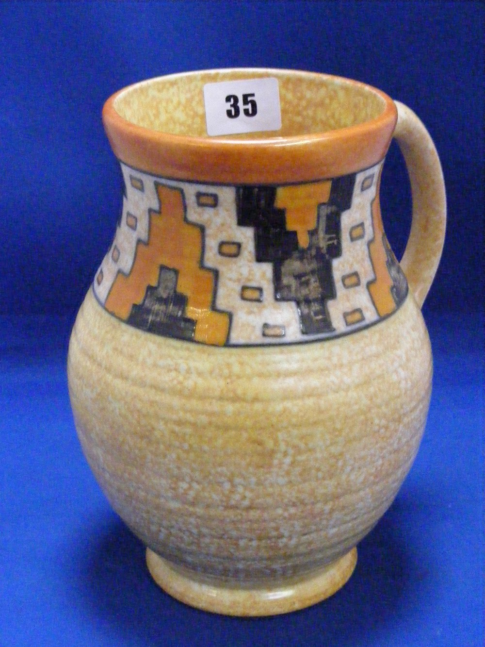 A Charlotte Rhead designed Crown Ducal vase decorated in predominantly orange colours and having a