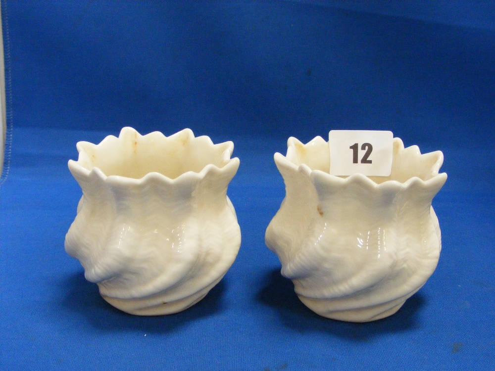 A pair of Belleek vases of sculpted shell form.