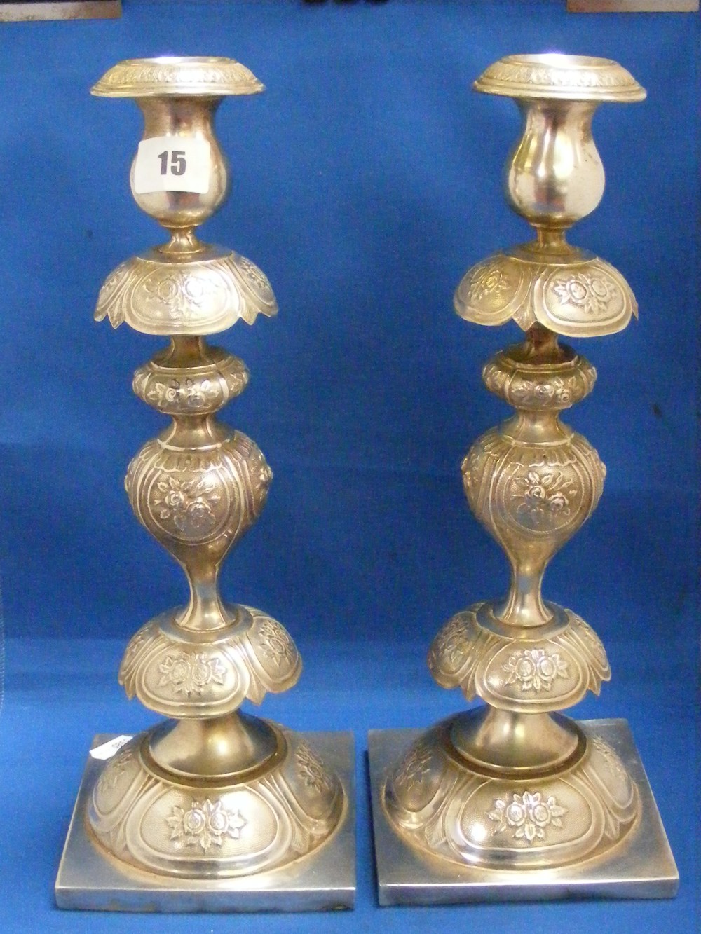 A pair of Continental white metal candlesticks of shaped bulbous design, height 36cms.