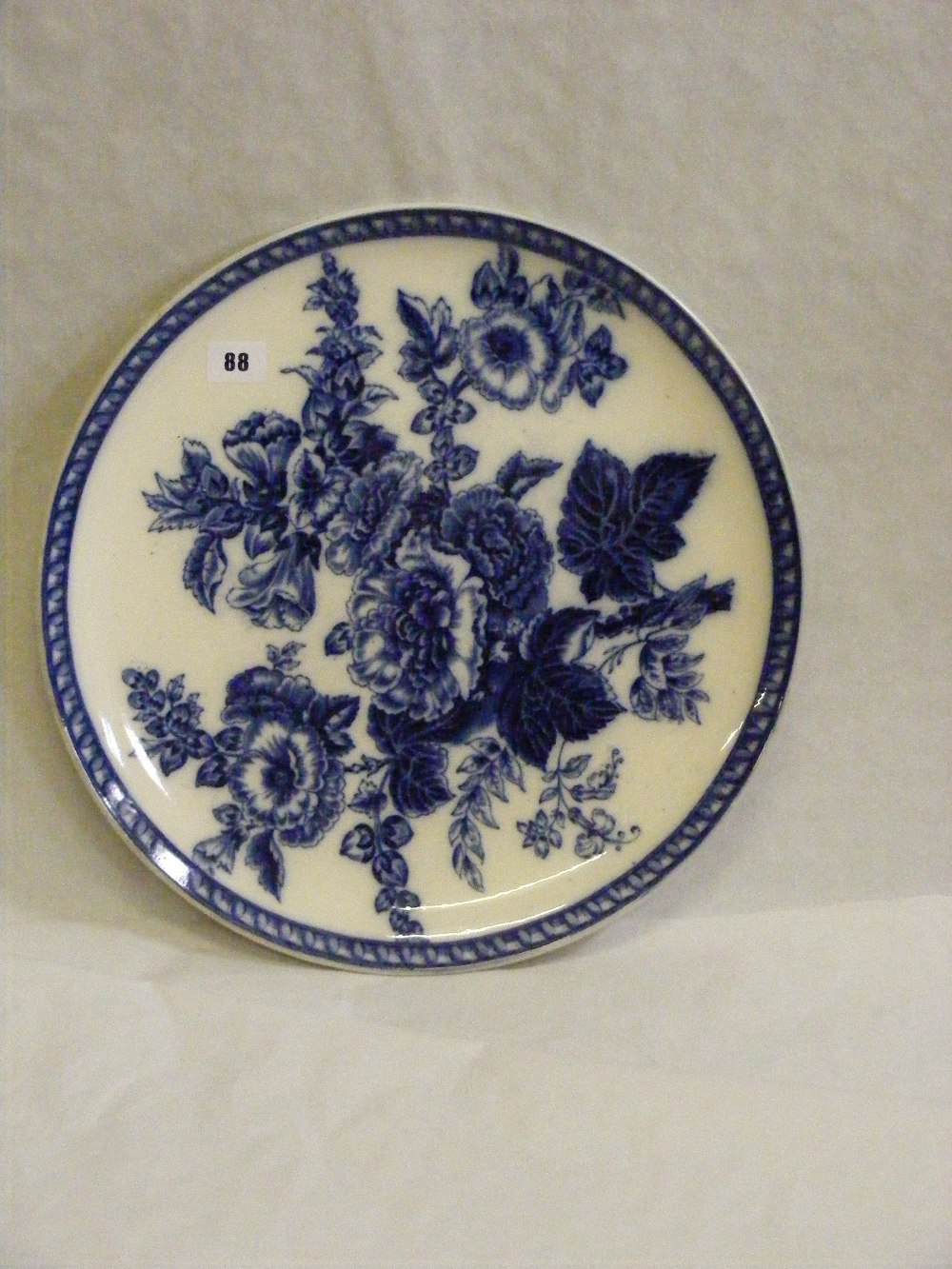 A large blue and white Wedgwood charger with floral decoration, dia. 42cms.