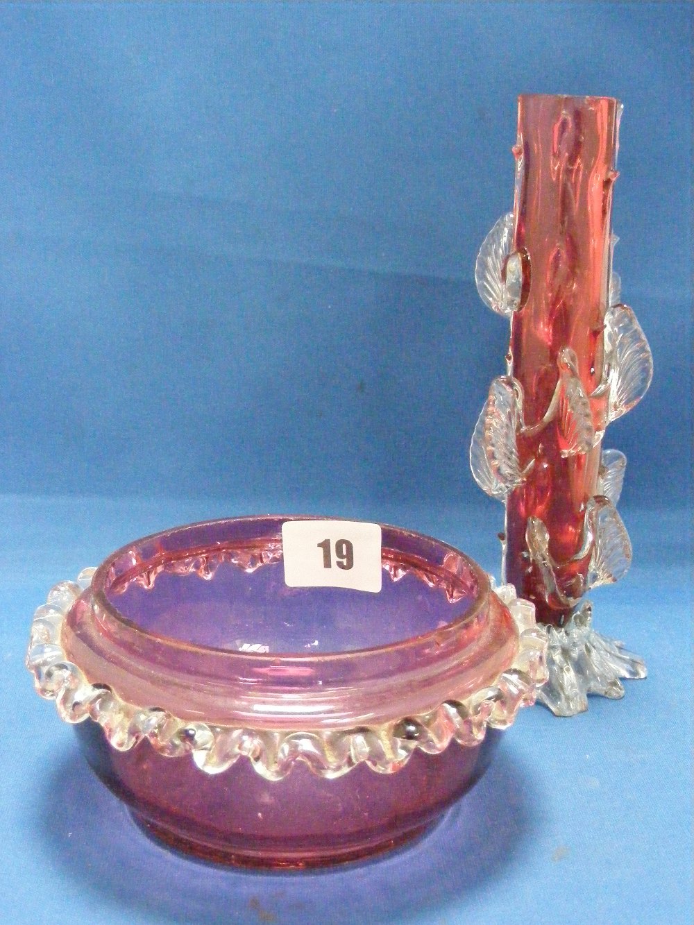 Two cranberry glass items, to include a dish with clear glass frill edging and a vase of