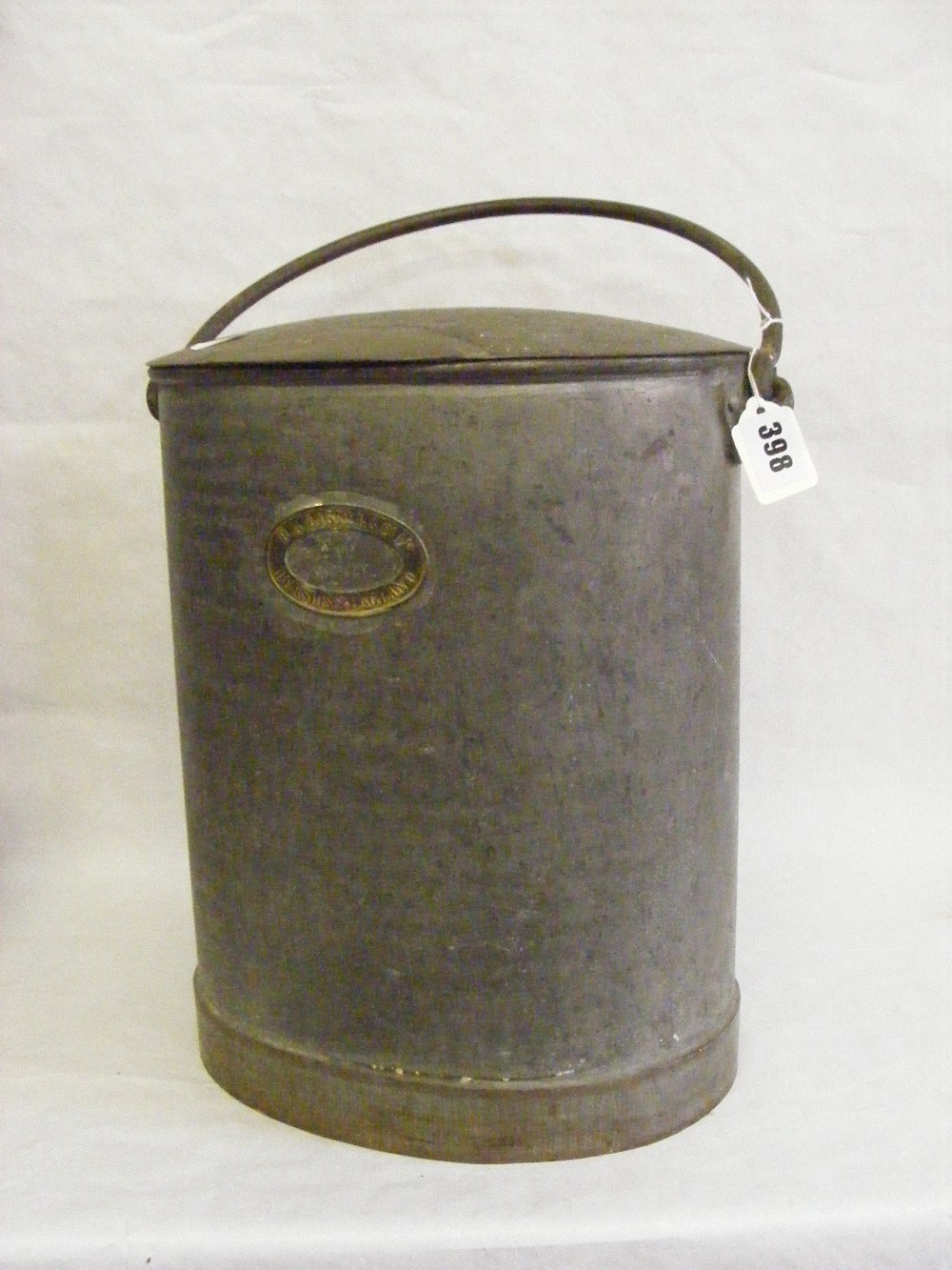 A vintage oval milk churn with handle, stamped R.A. Lister Dursley England.