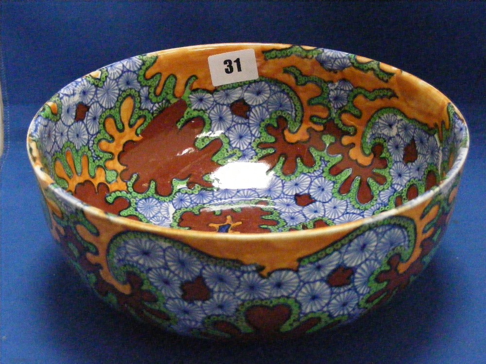 A highly decorative earthenware bowl marked Benares to base and decorated in blues, browns and