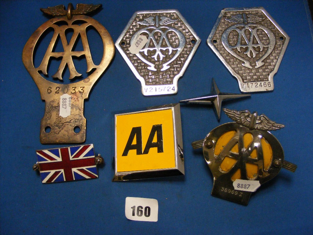 A collection of five vintage A.A. badges and a Union Flag badge.