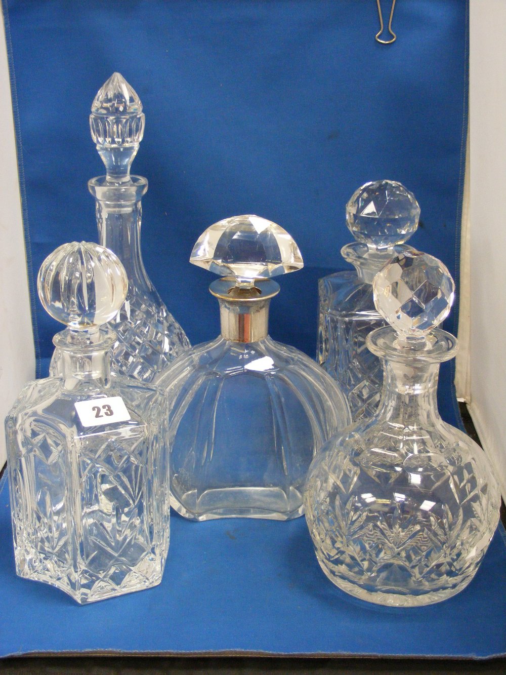 A collection of five various crystal and cut-glass decanters, to include one of hexagonal form and