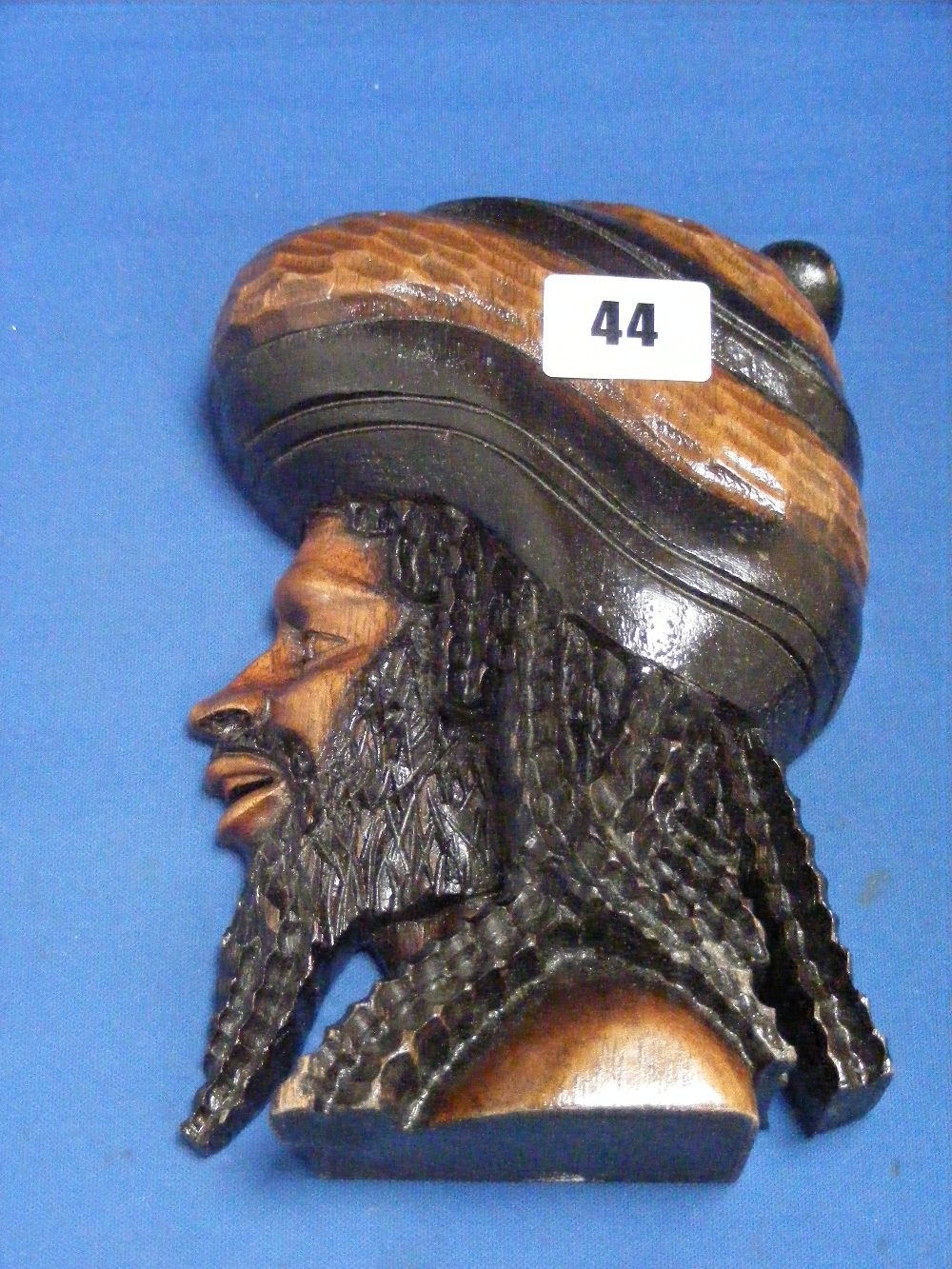 A carved wooden bust in profile of a Rastafarian man by Paul Walters 1988, this item won Mr Walter's