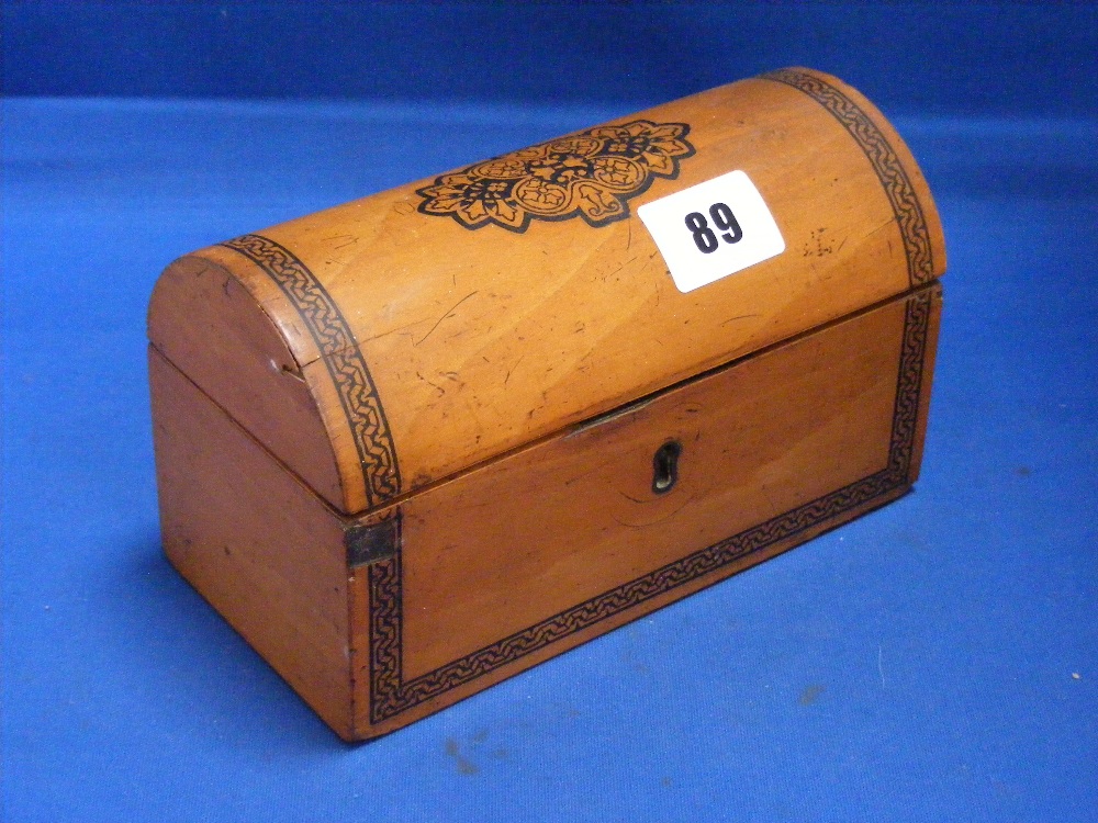 A domed top sandalwood jewellery box with inlaid cartouche and banding.