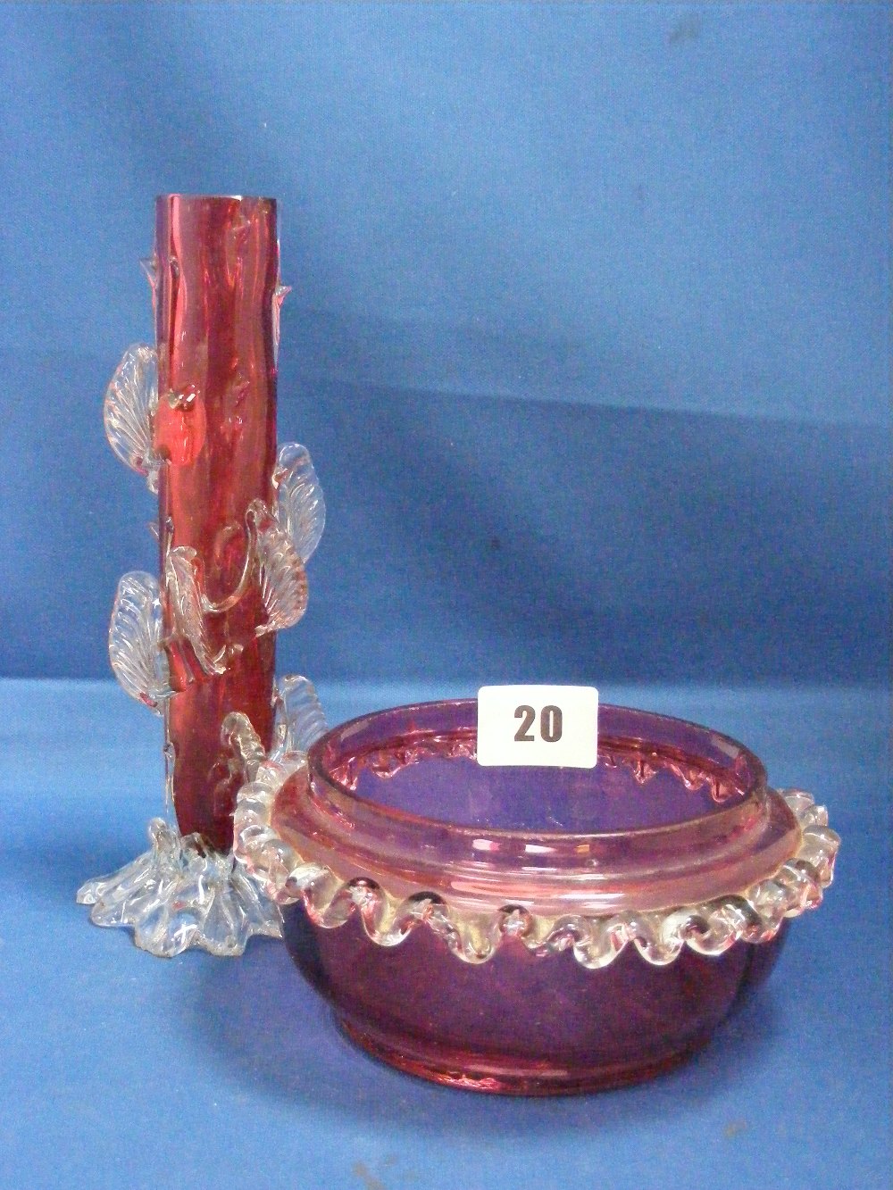Two cranberry glass items, comprising a naturalistic formed stem vase with applied clear glass