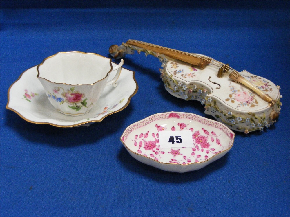 A Meissen pin tray of scalloped form decorated with pink flowers on a white ground, together with an