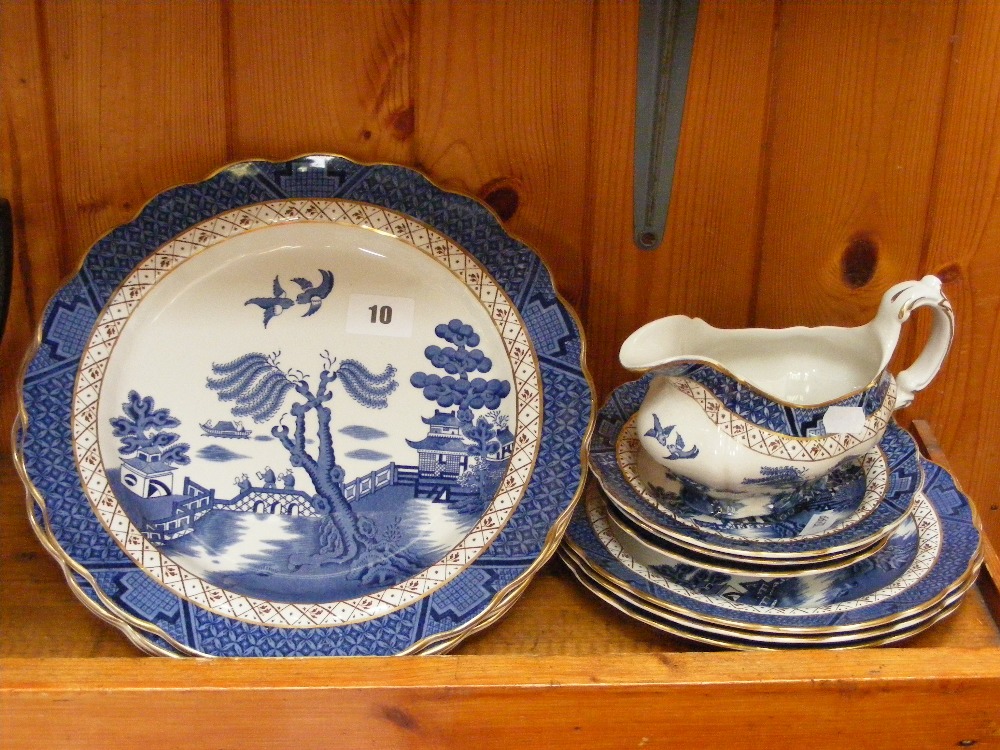 A collection of blue and white china items by Booths in the Old Willow pattern, comprising dinner