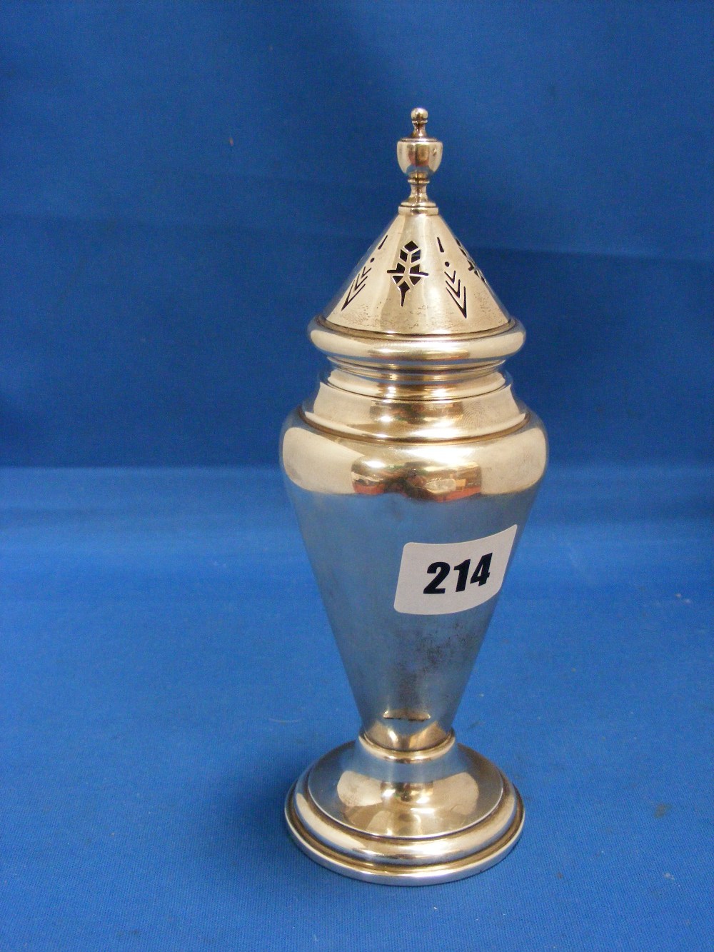 A very stylish English silver sugar caster of Art Deco design with an angled body and conical