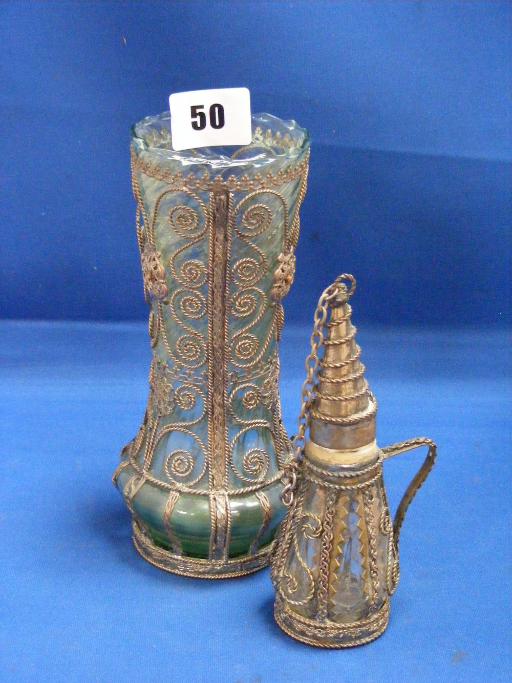 Two Middle Eastern metal work and glass items, to include a vase of waisted form and a miniature