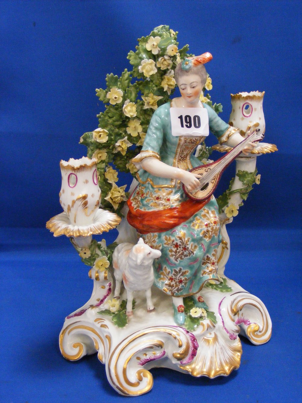 An early Victorian Chelsea porcelain 2-branch candelabra of a lady musician playing a lute with a