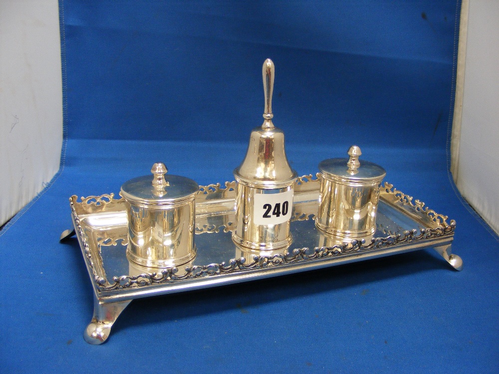 An elegant antique silver inkstand of fine quality with three cylindrical inkwells, two with