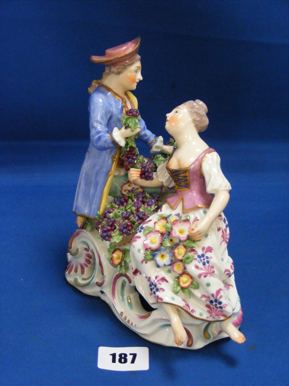 An antique Continental porcelain figural group, in the manner of Meissen, depicting a gentleman