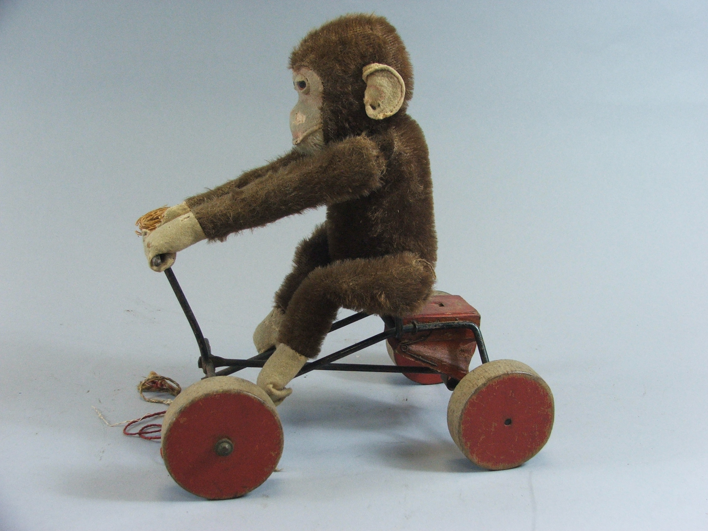 A Childs Pull Along Monkey Toy (Missing One Front Wheel)