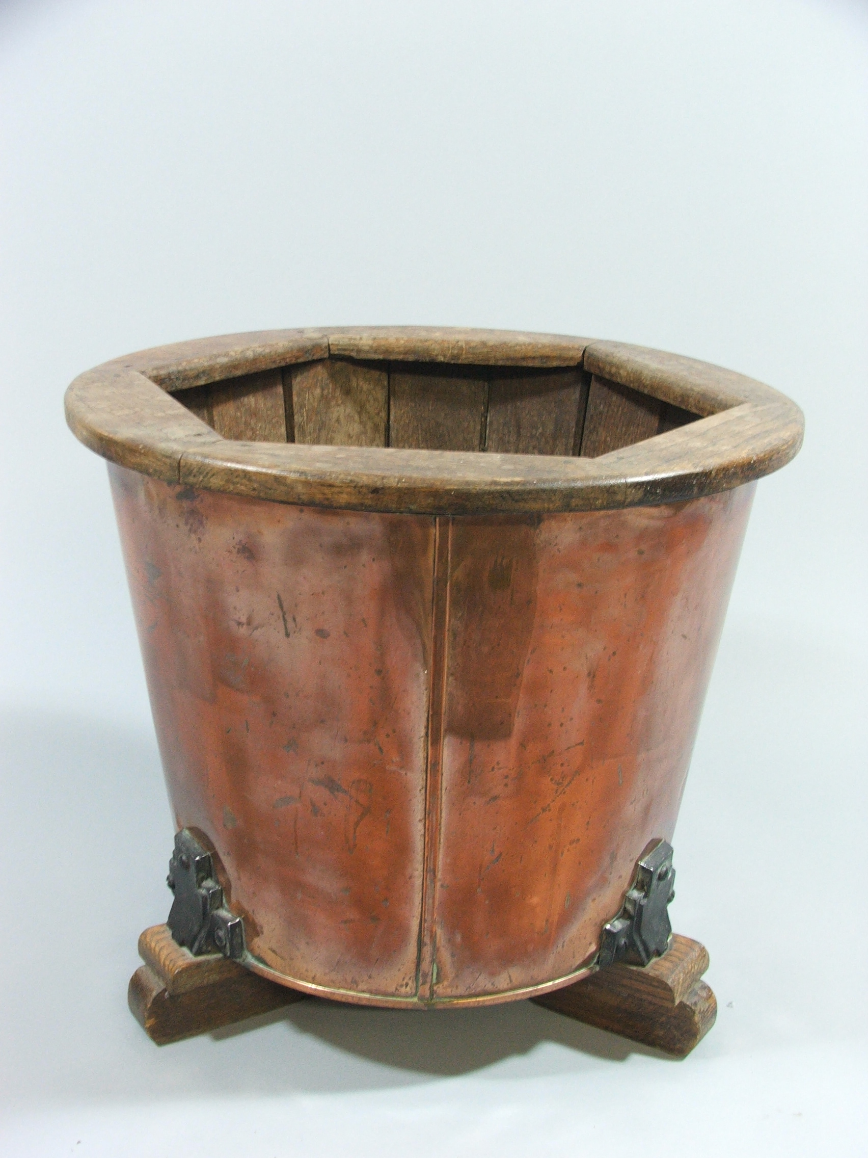 A Tapering Cylindrical Art Deco Copper Planter with Oak Inner and Three Feet.