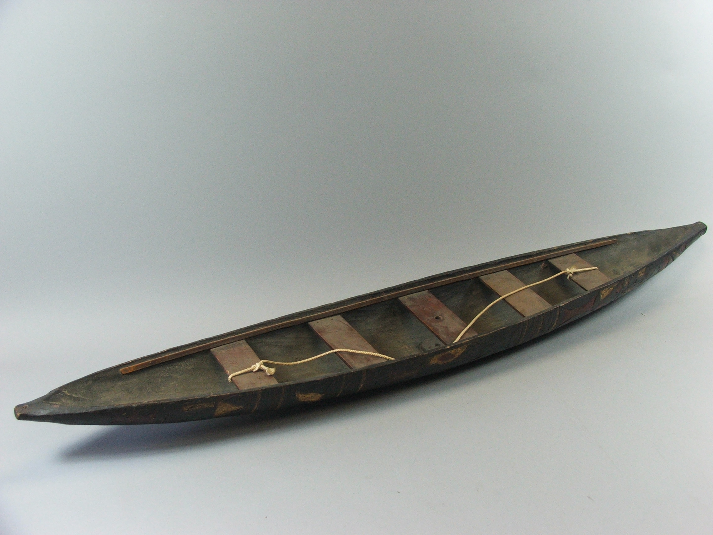 A Late 19th/Early 20th Century Model of a Five Seater Canoe, the Hull Carved and Decorated in