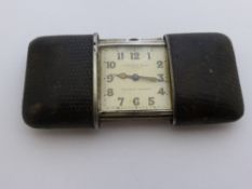 A vintage Corona Silver Travelling Clock, the snake skin slide out case by Ermeto-Movado, the case