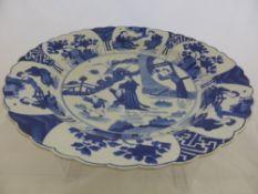 A Blue and White Charger the plate with pie crust rim features woman and children at play, Kangxi