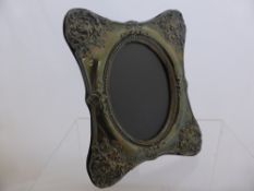 Silver Easel Oval Photo Frame, London hallmark, dated 1985, the frame decorated with foliate