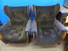 G-plan Armchairs - two wing back saddle arm chairs, covered in vintage upholstery.