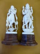 Ivory Figures Two antique Indian Ivory Figures depicting Deity on hardwood stands. The first