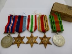 Group of five medals in card box addressed to Mr G E Boyles, 53 Totty Street, London, E 3 and