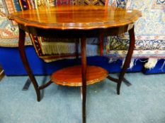 An Edwardian oval mahogany occasional table having a scalloped edge with an under shelf on