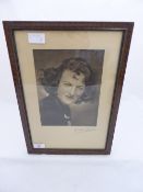 A black and white photograph of Gracie Fields, signed