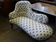 A Victorian mahogany chaise longue having floral embroidered upholstery.