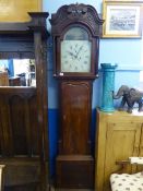 An antique mahogany long case clock with hand painted arched dial depicting a country scene,