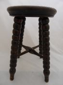 Antique Oak carved stool, on bobbin legs with tapered feet and crossed stretchers.