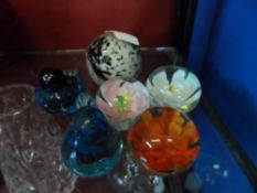 Collection of Paperweights including three orange, white, and pink floral paperweights and two