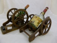 Two brandy holders in the form of gun carriages together with an Embassy billiard cue and a set of