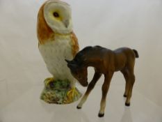 Two Beswick figures of a pony and an owl together with a resin figure of an owl. (3)