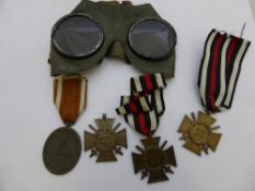 A pair of first world war leather tinted glass goggles and three German 1914 / 18 military stars,
