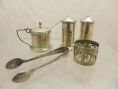 A silver mustard pot and salt and pepper, Birmingham hallmarked, together with a napkin ring and